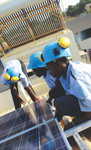 Solar power panels are handled by a group of people